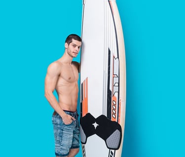 a man holding a surfboard while standing next to a surfboard