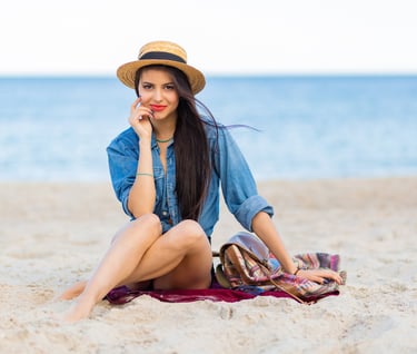 a woman sitting on a blanket on a blanket