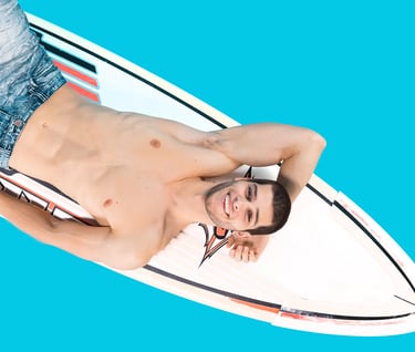 a man laying on a surfboard in the ocean