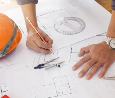 a person holding a pencil and a ruler