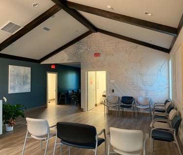 commercial office construction showing a waiting room with chairs and a map of a map