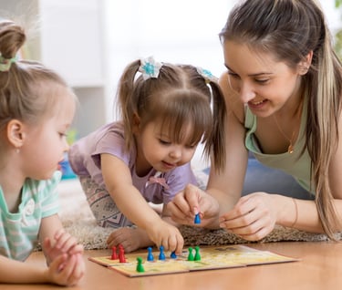 mom and toddlers playing board game