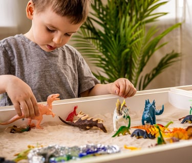 toddler playing with sensory bin