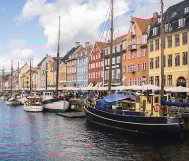a boat in the water near a row of buildings