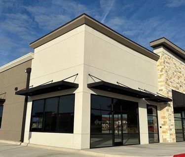 Commercial building with two tones of stucco colors and Texas Mix limestone in a random ashlar.
