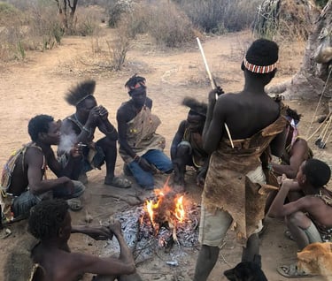 a group of people sitting around a fire pit