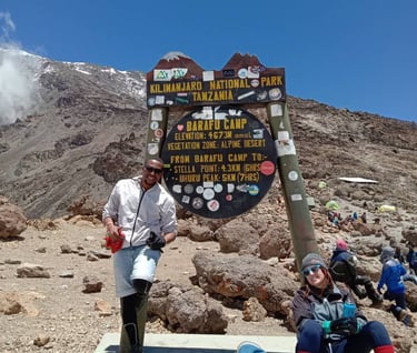 a man and woman standing in front of a sign