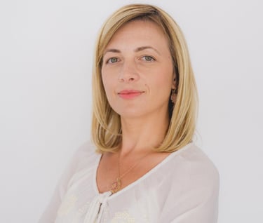 a woman with blonde hair and a white shirt