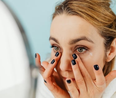 Woman applying face cream in the morning