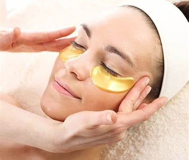 a woman with a gold eye mask on her face