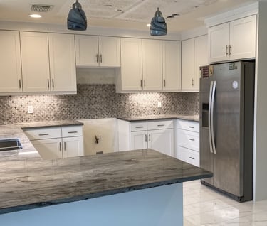 a kitchen with white shaker cabinets