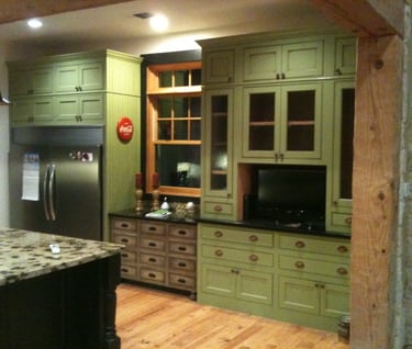 a kitchen with green farmhouse cabinets