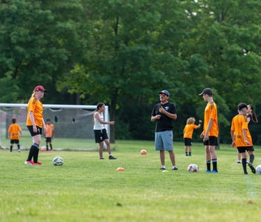 A MVB FC soccer coach instructs youth player In Mississaugas