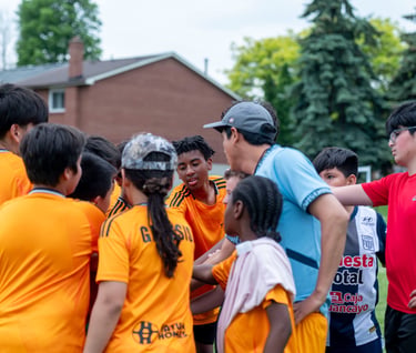 MVB F.C. soccer players gathers in a huddle with their coach In Mississauga Ontario