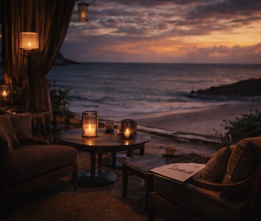 Luxury beach lounge at sunset with comfortable seating, candles, and a scenic ocean view.