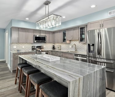 a kitchen with a marble counter top and a chandelier