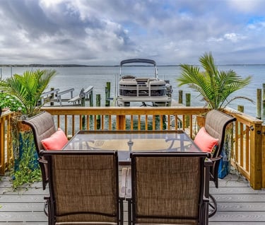 a table with chairs and a boat dock