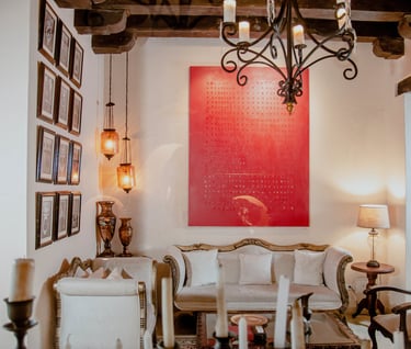a living room with a red painting on the wall