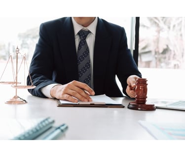a man in a suit and tie is sitting at a desk