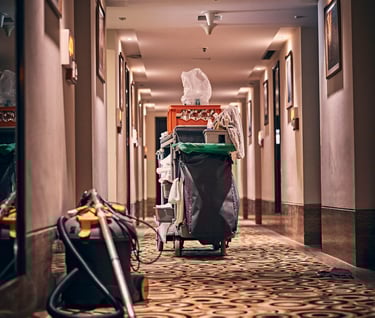 a cleaning machine in a hallway with a trash canister