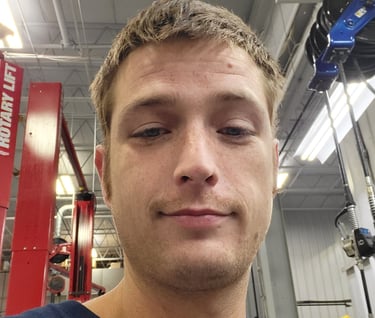 a man in a blue shirt is looking at the camera