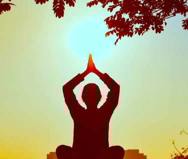 A person standing outdoors with their hands clasped overhead in a gesture of reverence or gratitude.