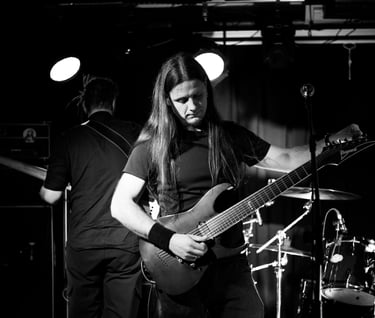 a man tuning guitar on stage