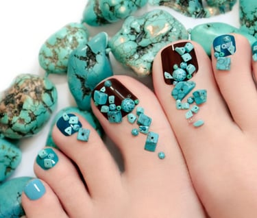 a person with a blue and green pedicures on their toes