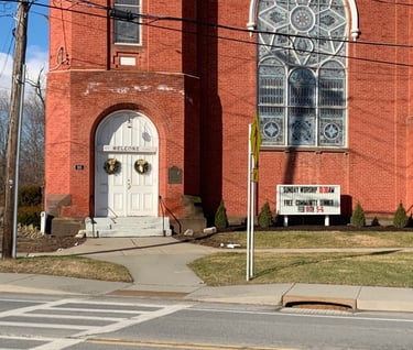 Image of the front of the Presbyterian United Church in Schaghticoke NY with "All are welcome" sign