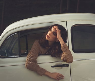 a woman leaning out of a car window