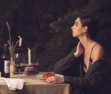 a woman sitting at a table with a plate of food