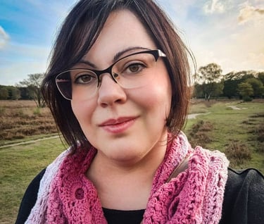 Doula Valentina - me- a woman in glasses and a pink scarf around her neck