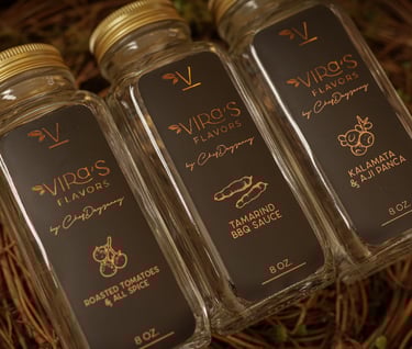 three bottles of sauce in a nest with a nest of grapes