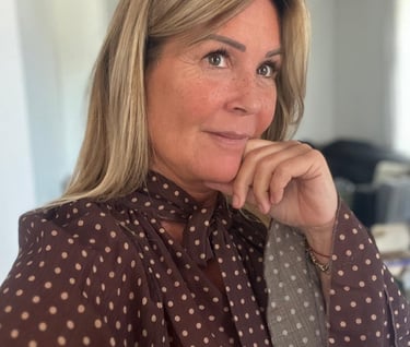 a woman with blonde hair and a polka dotty blouse