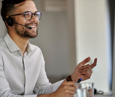 a man with a headset and a headset on a computer
