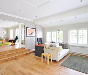 Living room that has beautiful hardwood floors and wood stairs