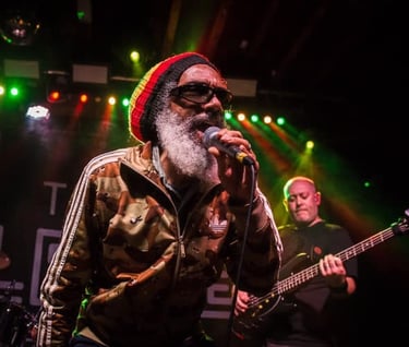 HR of Bad Brains performing live music entertainment on stage at concert with J Phoenix Booking Agen