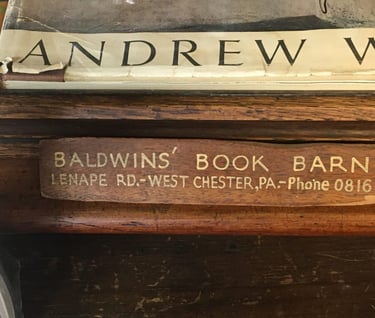 a wooden sign that says Baldwins book barn, and a picture of a book barn sign