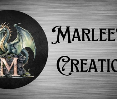 a dragon standing on a M and a sign that says marleekat creations