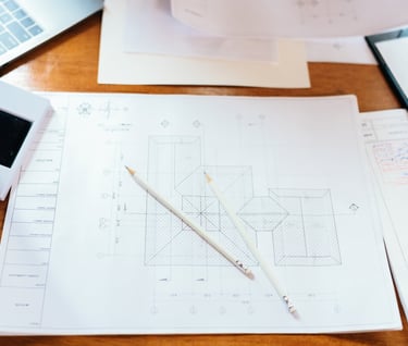 a desk with a laptop and a pen and pencil
