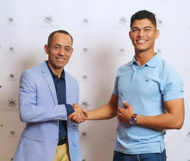 two men shaking hands in front of a wall with a wallpapered wall punta cana