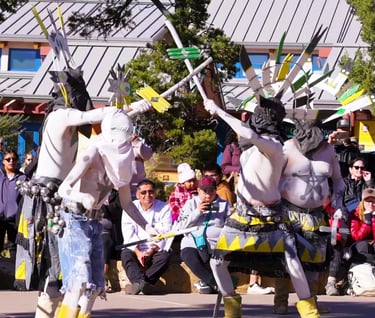 people in ceremonial costumes performing on at Grand Canyon National Park