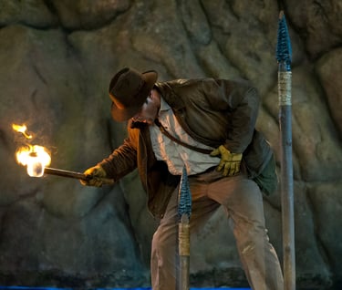 a man in a suit and tie is holding a torch