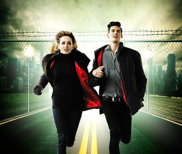 a man and woman running down a road away from a city