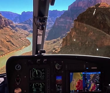 POV from inside a helicopter cockpit flying over the Colorado River in the Grand Canyon for Soarin' Across America.