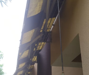 a yellow and black awning on a building repair
