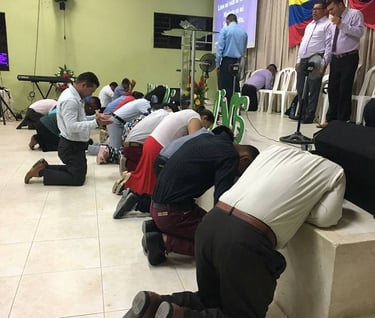 a group of people kneeling down on a stage
