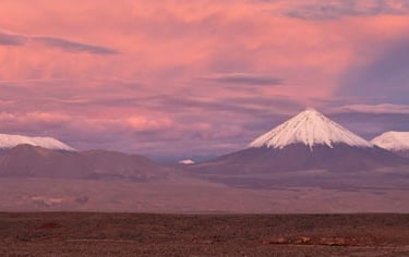 a mountain range with a mountain in the background