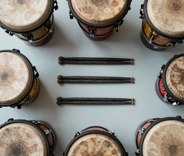 A top-down photograph of various colorful percussion instruments and Dark Charcoal drumsticks arranged neatly on a Light Mist surface, bright and funky aesthetic in a International / English-speaking music room.