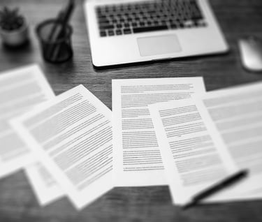 set of paper sheets with palin text spread across a wooden working desk